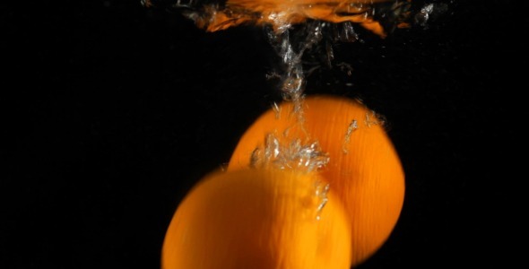 Fresh Oranges In Water On Black