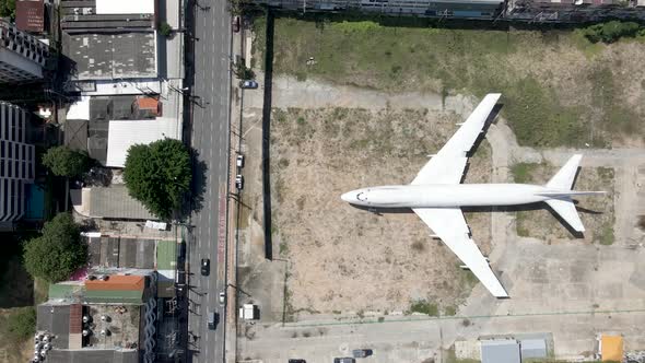 White Plane Emergency landing in the middle of a city, aerial fly over abandoned plane