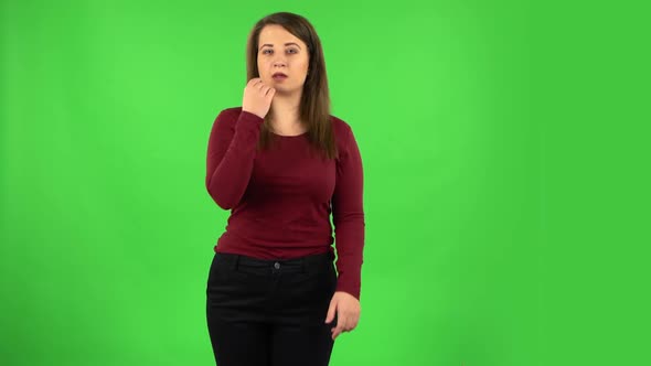 Pretty Girl Smiling and Showing Heart with Fingers Then Blowing Kiss. Green Screen