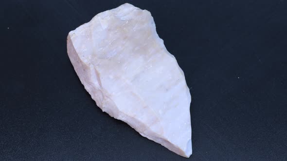 Sharp prehistoric flint stone knife, macro shot with rotation motion.