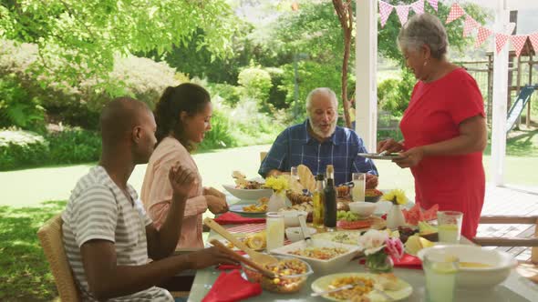 Multi-generation African American family spending time in garden together