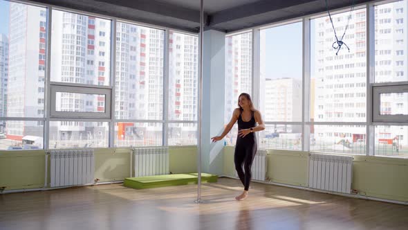 Young Happy Woman with Medical Mask Dances in Room During Home Isolation. Use Time of Quarantine