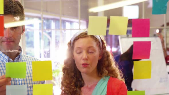 Group of business executives interacting over sticky notes