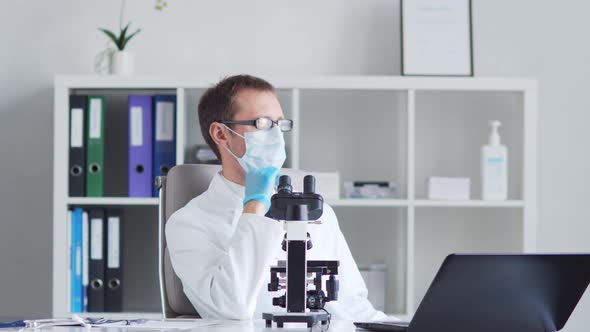 Professional medical doctor working in hospital office using computer technology.