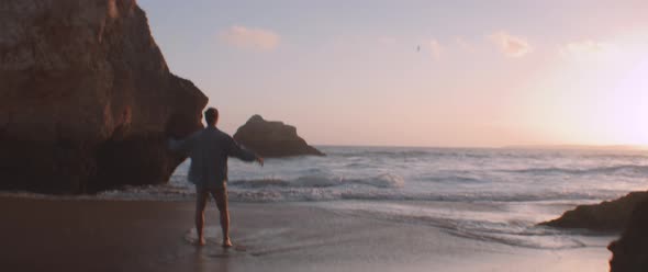 A young guy stretching and relaxing on the beach