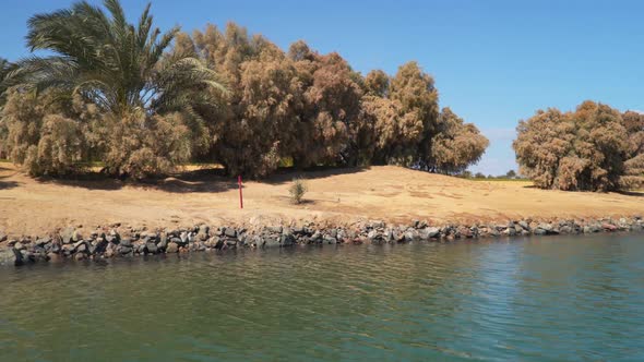 The shore of a tropical island. View from a sailing boat