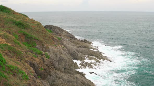 Waves on The Azure Water in The Tropical Sea. an Island with A Rocky Shore and Green Plants