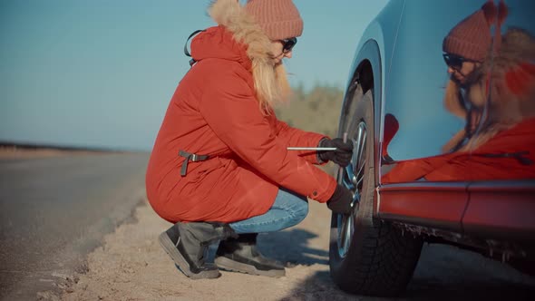 Woman Check Car Tire Pressure. Vehicle Trouble On Road On Vacation Trip. Female Trying Fix Car Tire.