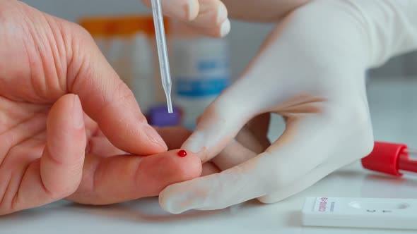 Doctor in Hospital Taking Blood Drop From a Patient Finger