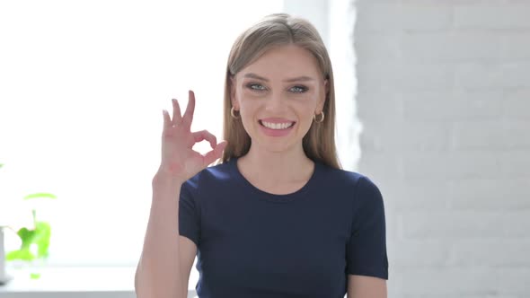 Portrait of Woman Showing Ok Sign with Finger