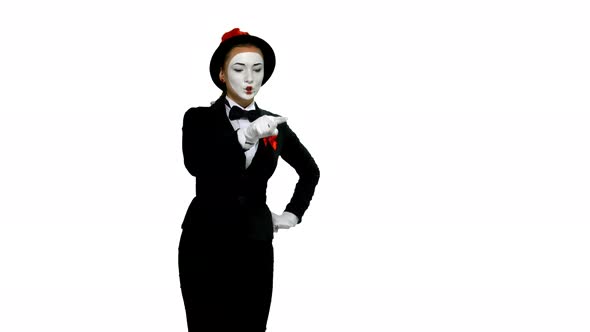Woman Mime Writes Something in Air on White Background