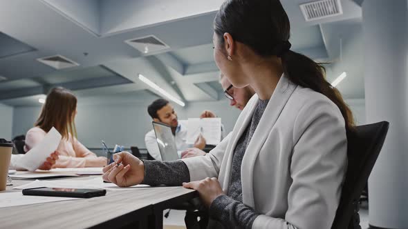 Asian Female Writing Down Information Heard From Boss Who Explaining Details of Startup Project to