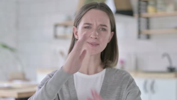 Portrait of Young Woman Saying No with Hand Sign