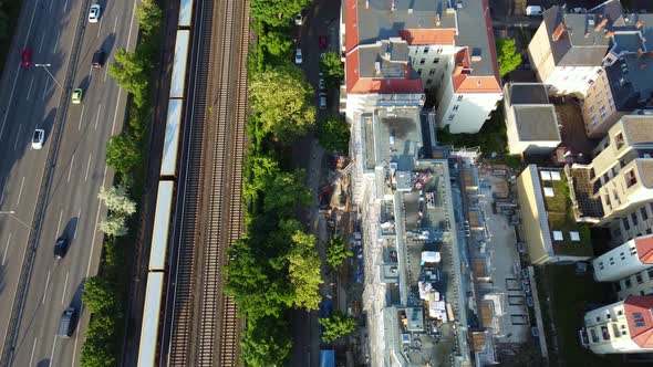 cars on Autobahn, S-Bahn Train, street.Unbelievable aerial view flight subject out of view drone fo