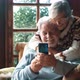 Senior couple have fun together at home using mobile phone to do video conference call - VideoHive Item for Sale