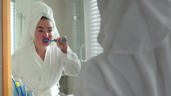 Portrait Happy Cute Young Teenage Girl Brushing Teeth in Bathroom and Smiling