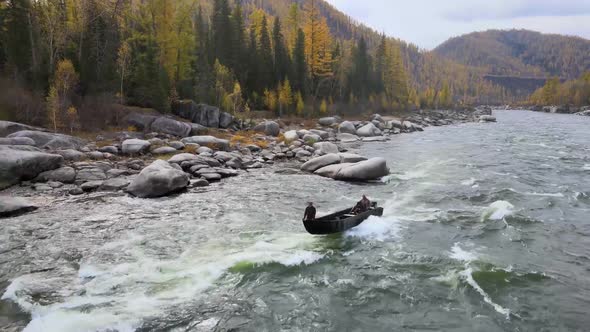 People Are Sailing on a Motor Boat on a Stormy River Autumn