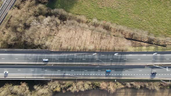 Aerial Top View of Highway and Small Bridge Surrounded By Farmland