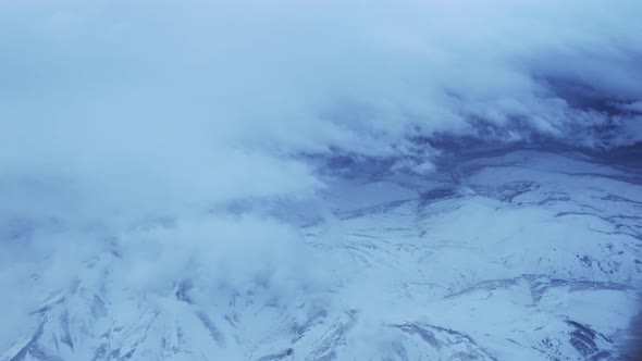 Flying Over The Snowy Mountains in Winter