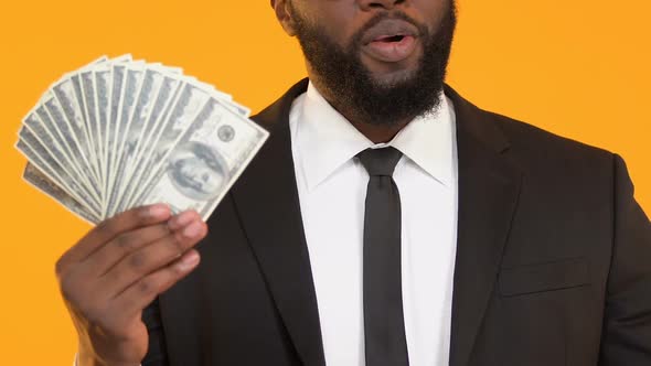 Excited Black Male Pointing Finger to Bunch of Dollars, Credit Services, Banking