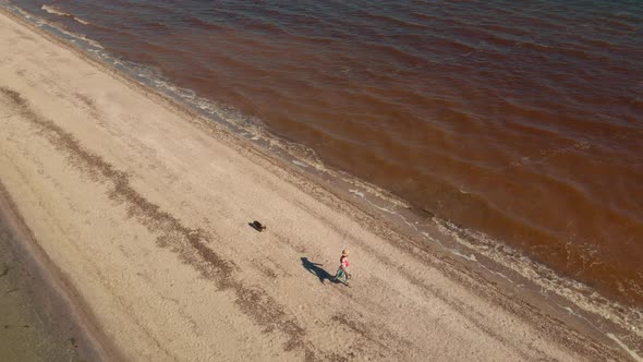 Two People Running By Sand Beach Coastline Sand Bar at Mykolaiv Region Ukraine