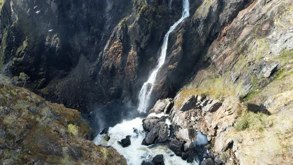 Aerial Dolly Forward To Reveal Overhead View Of Cascading Voringsfossen Waterfall In Norway.