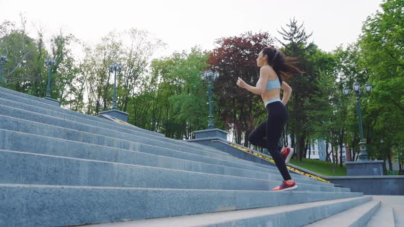 Slow Motion Woman Jogging on Stairs Outside