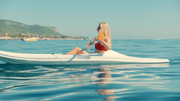 Paddling Canoe Adventure. Tourist Woman Spending Day Kayaking On Sea. Active Woman Having Fun.