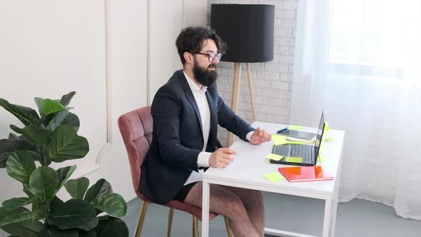 Bearded Man Comfortable at His Desk Having a Video Call Conference