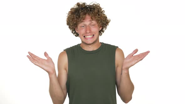 Picture of Blond Curly Man Throwing Up Hands Expressing He is Innocent Saying Oops He Doesn't Know