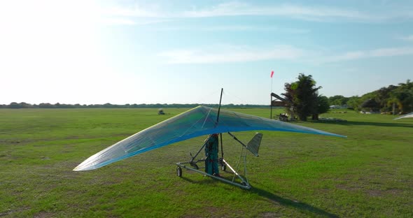 Circling as hang glider pilot gets ready on the ground