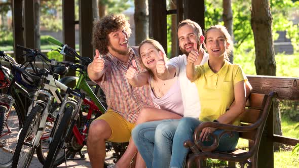 Young Cheerful People Gesturing Thumbs Up