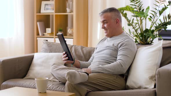 Man Having Video Chat on Tablet Pc at Home 