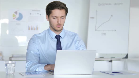 Young Businessman Working on Laptop