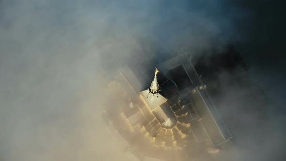 Beautiful Cinematic Aerial Shot of Cloudy Castle Spire of Mont Saint Michel, Iconic Fortress Island