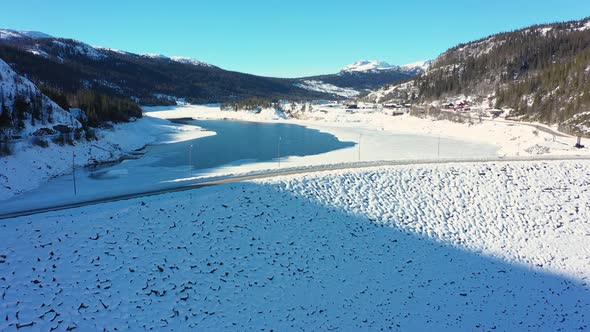 Slow aerial view of  Statkraft operatedTunhovd dam with Tunhovdfjord water reservoir inside - Low fi