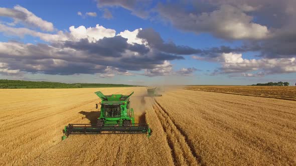 Combine Harvesters and Cloudy Sky.