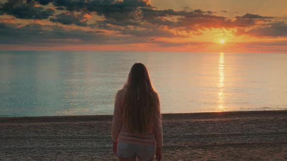 Woman with Long Hair Walking To the Sea