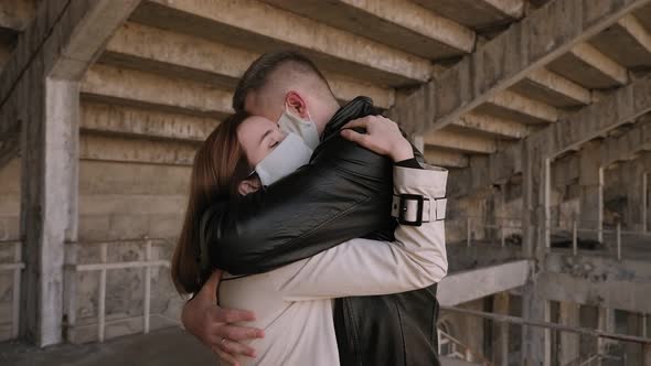 Couple in Medical Masks on Their Faces Hugging After Long Separation. Quarantine