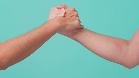 Close up shot of strong man make arm wresting of two men in isolate green screen in background.