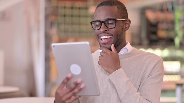 Portrait of Excited African Male Design Celebrating Success on Tablet