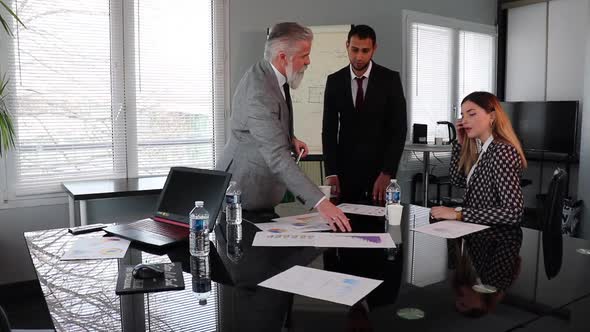 Business People Using Computer At Meeting