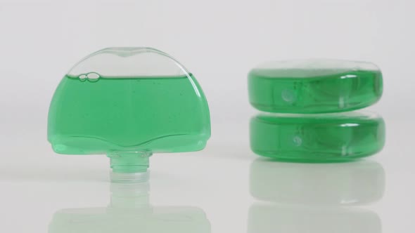 Green gel bowl fresheners on white slow tilt 4K footage