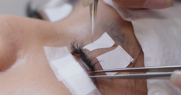 Woman having eye lash extension process