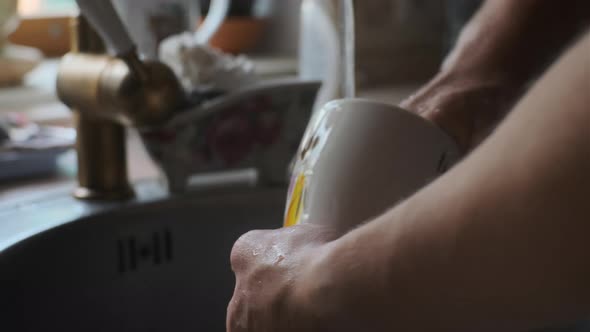 Close Up View Man Washes White Glass in Old Kitchen