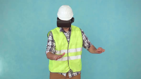 Man in a Helmet and Uniform Uses a VR Helmet