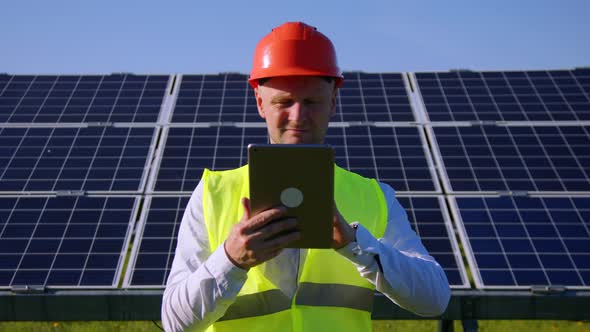 Engineer Working Use Tablet Near Solar Batteries Construction Renewable Power Worker Man Technology
