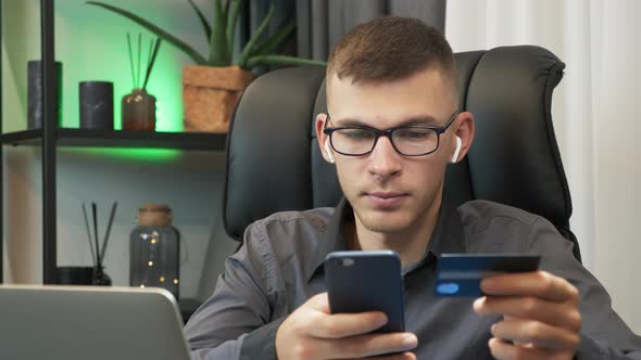 Man is using bank credit card for online shopping, doing online payments through internet bank card