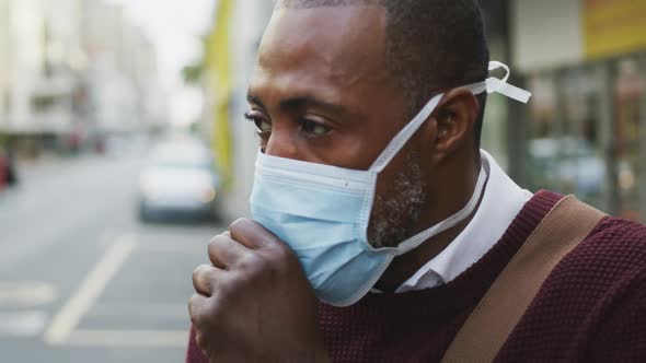 African american man on the go wearing coronavirus covid19 mask