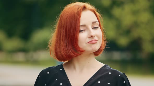 Close Up Portrait of Caucasian Young Girl Student Redhead Woman Stand in Park Outdoors Negatively